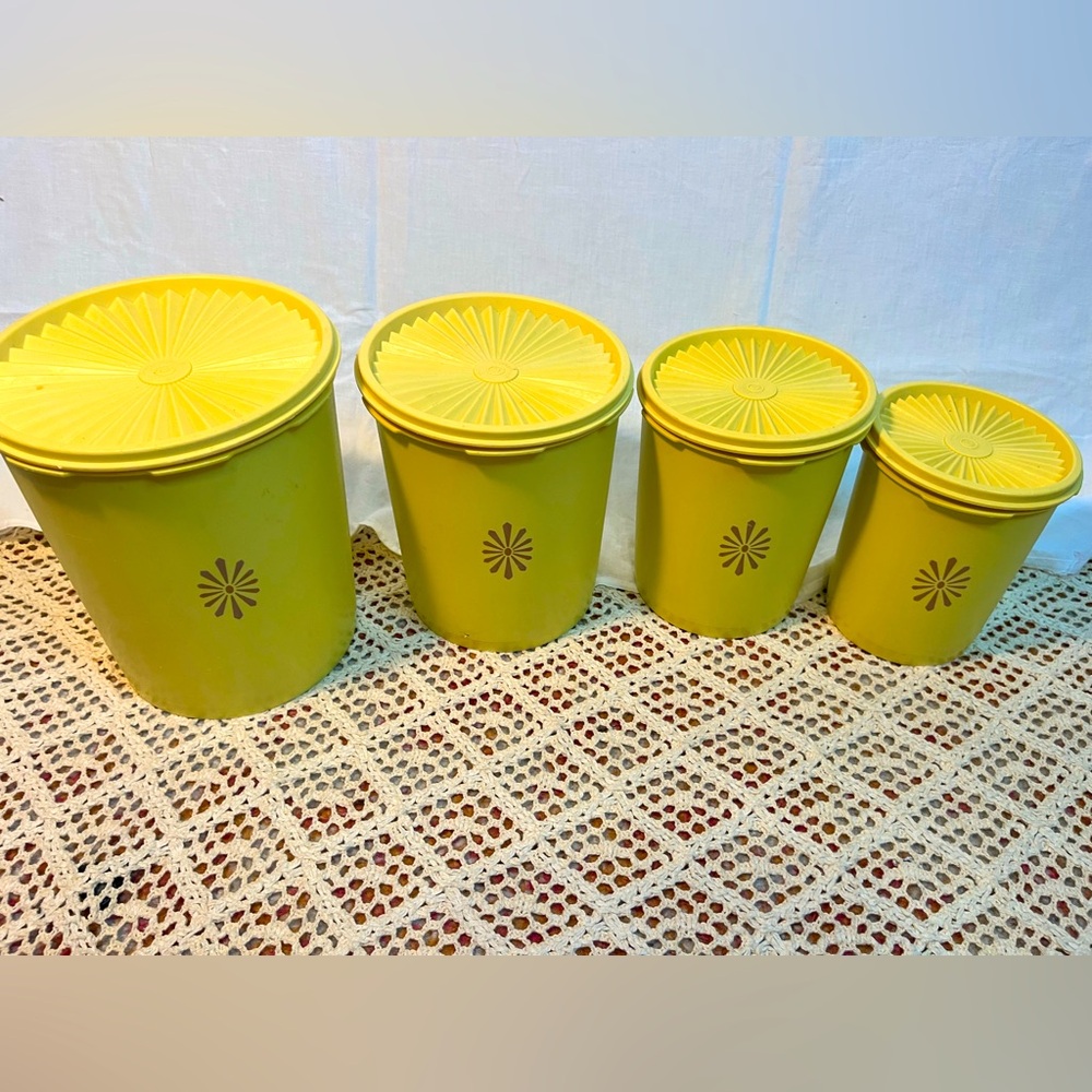 Set of 4 harvest gold Tupperware food canisters.